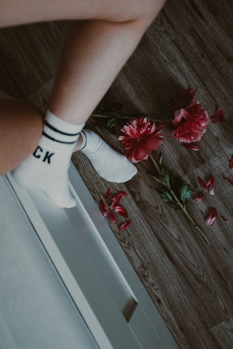 Woman Legs Wearing Socks And Flowers On Floor