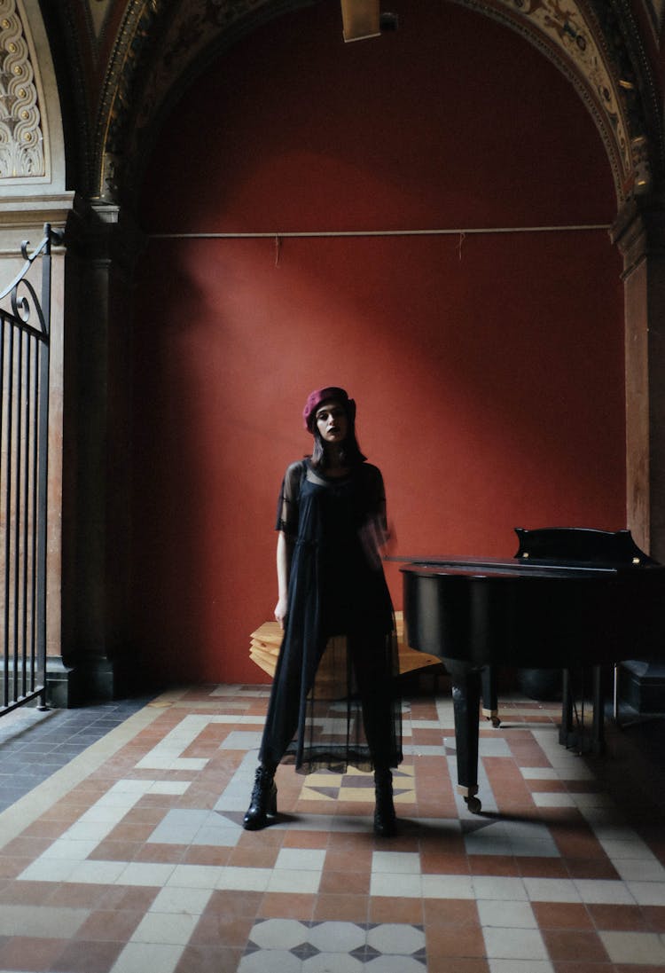 Stylish Woman Near Grand Piano In Old Building