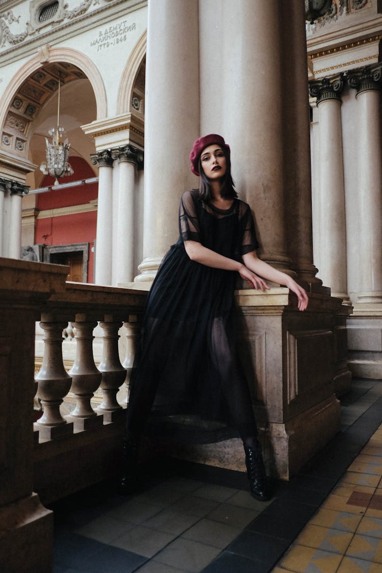 Gorgeous Model In Trendy Clothes On Fenced Balcony In Building