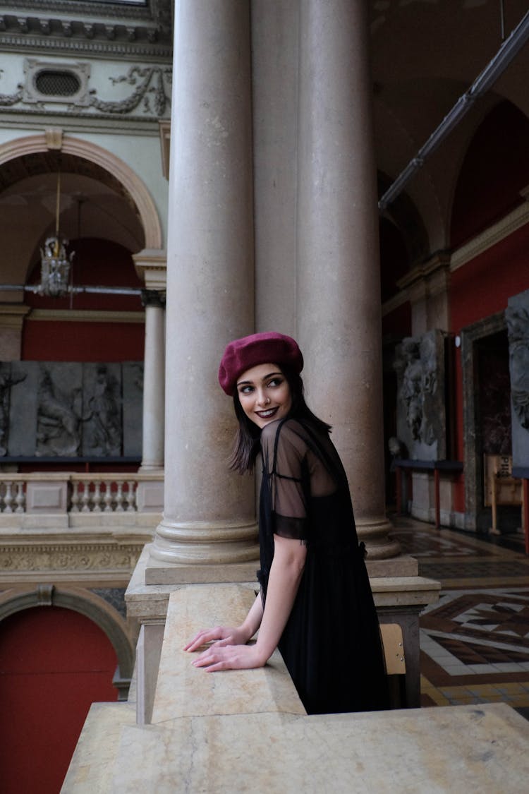 Cheerful Woman In Elegant Clothes On Fenced Balcony In Building