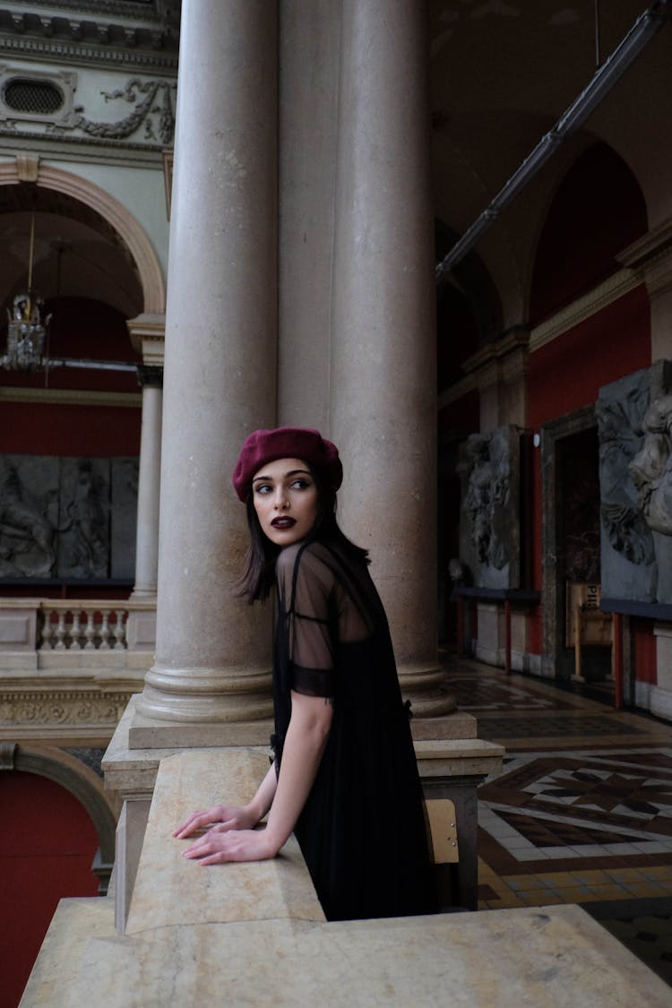 Stylish Pondering Woman With Makeup Near Old Fence And Columns