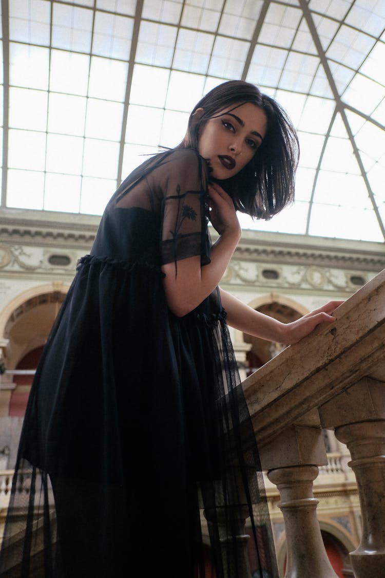 Elegant Woman With Makeup Touching Neck In Old Stone Building