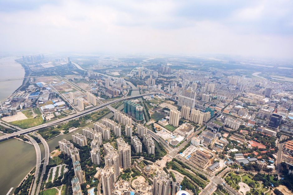 Breathtaking Family Pack 77 Miles Helicopter Tour Fireworks & All Theme Parks Review 2026 - Drone view of modern city district with modern buildings and roads located near river against cloudy sky in summer day
