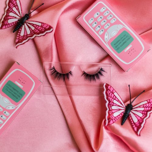 Eyelashes, Butterflies and Fliers on Pink Background