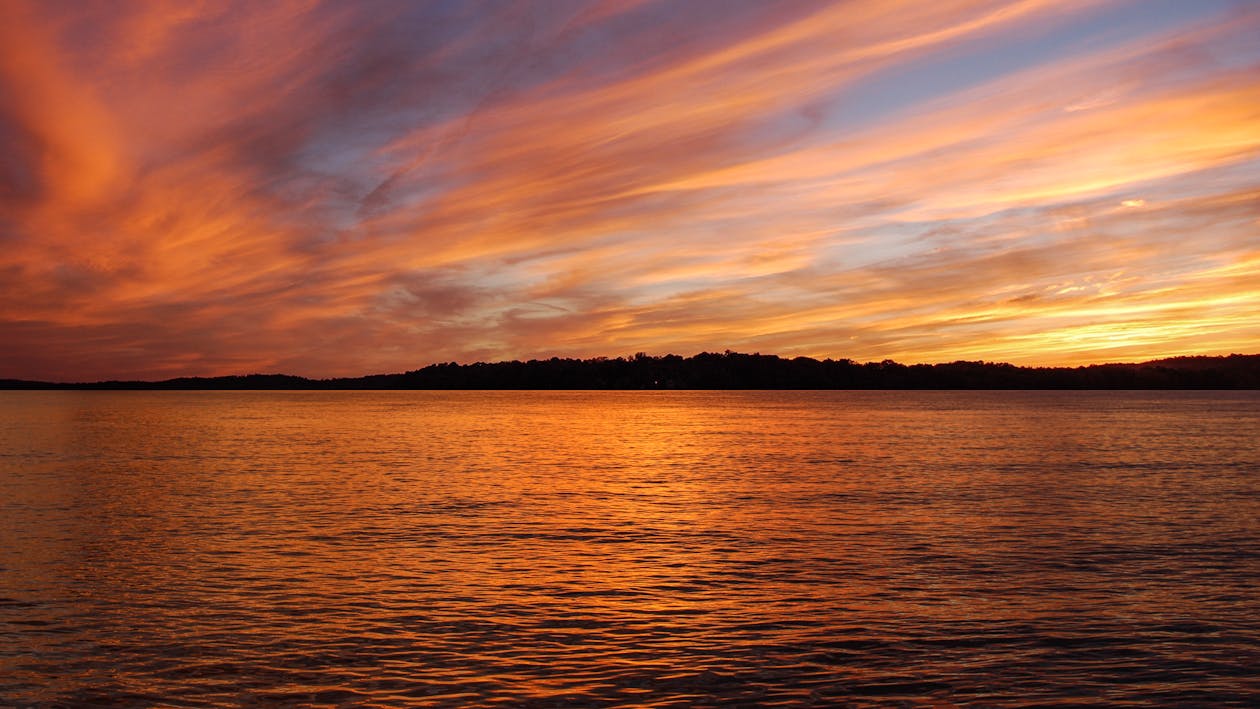 Scenic View of Placid Sea during Sunset