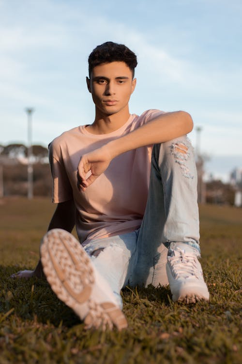 A Man Wearing a Pink Shirt and Denim Pants