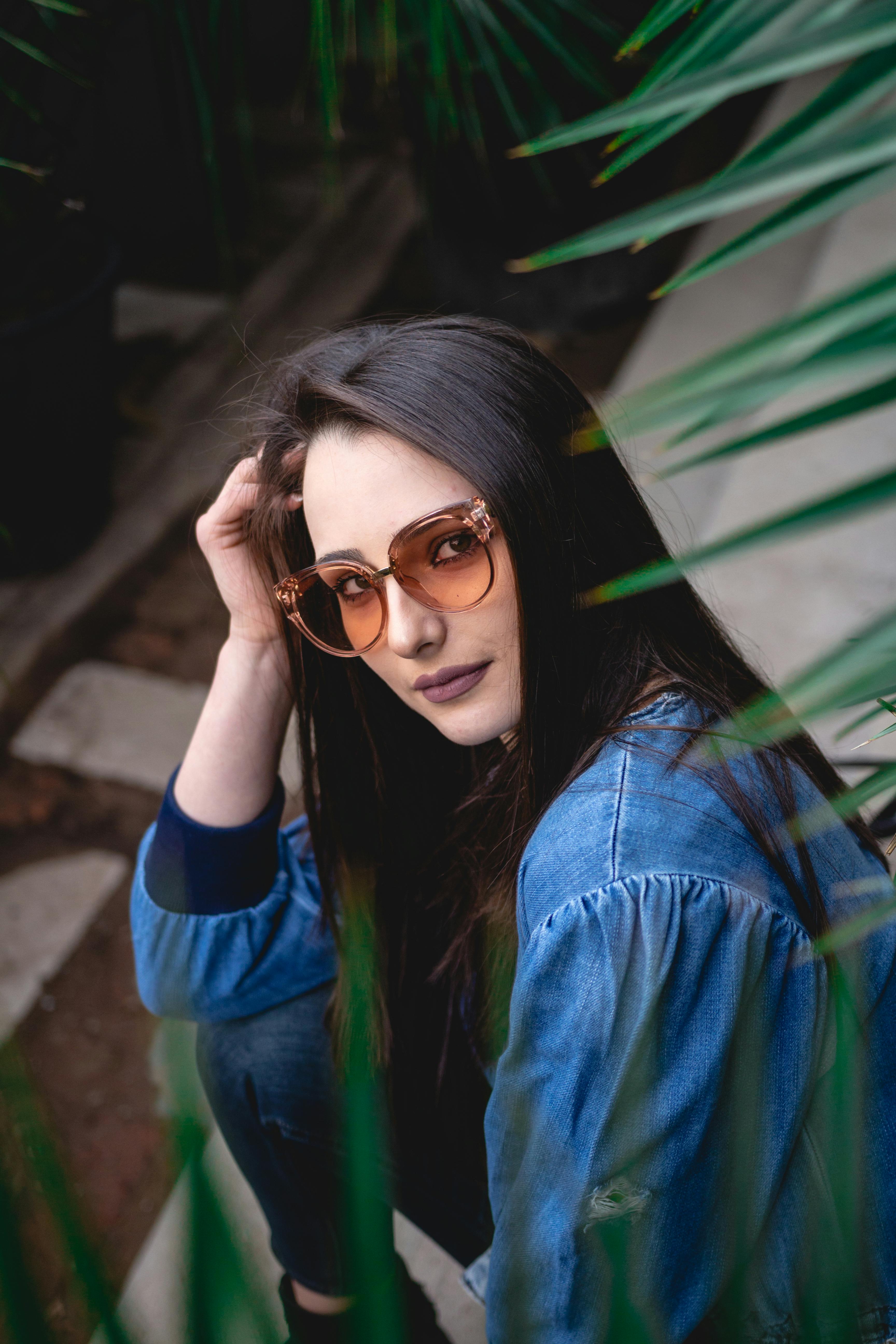 Woman in Blue Denim Jacket Wearing Brown Sunglasses · Free Stock Photo