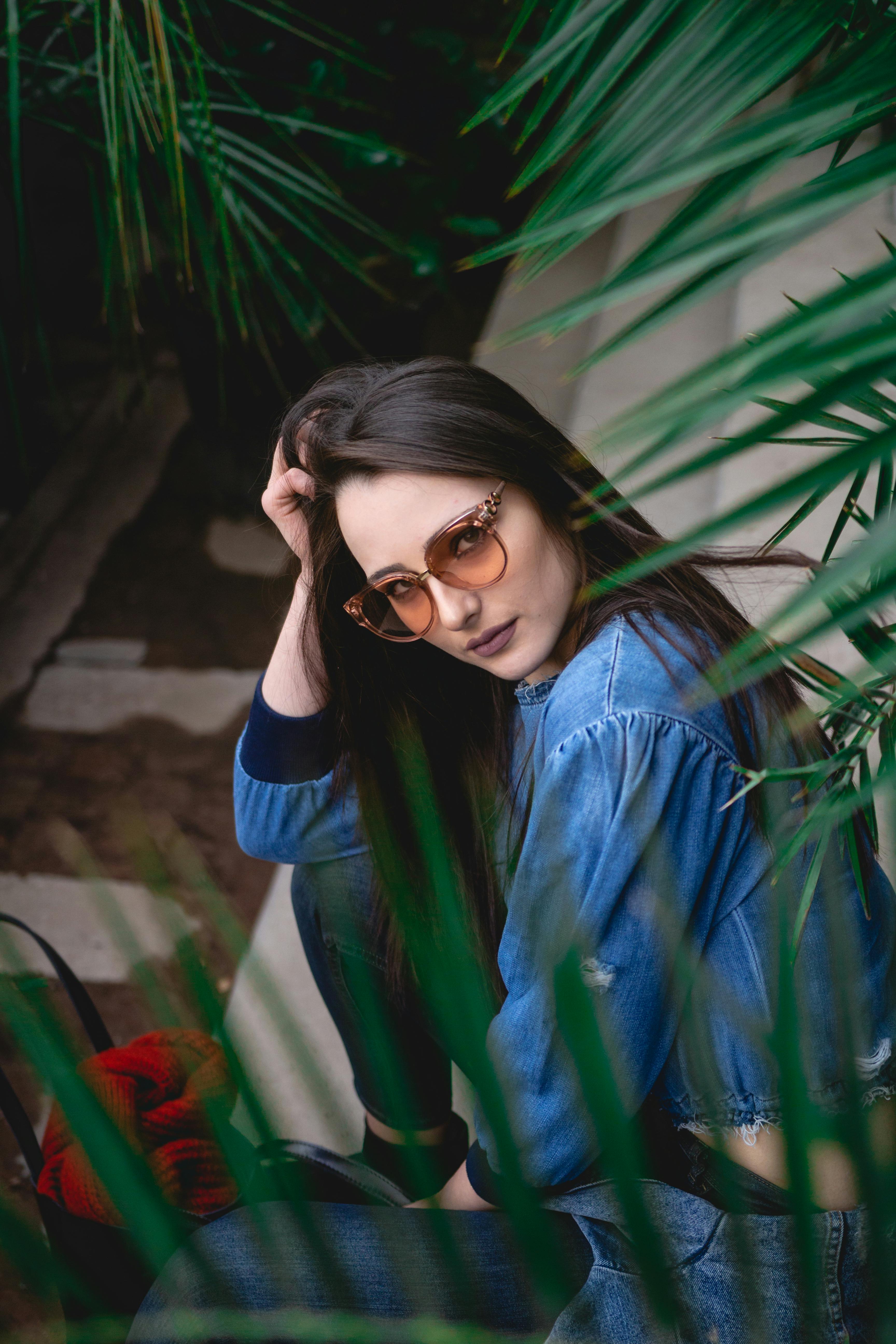Woman Wearing a Sunglasses Holding Vine Plants · Free Stock Photo
