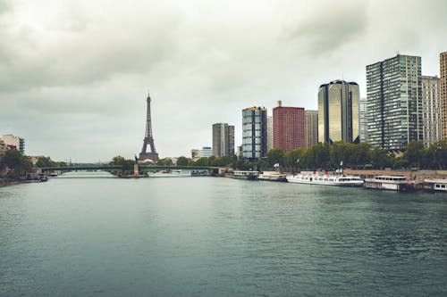 Buildings and Eiffel Tower Under Cloudy Sky