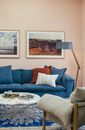 Stylish interior of living room with comfy couch and armchair and trendy decorations