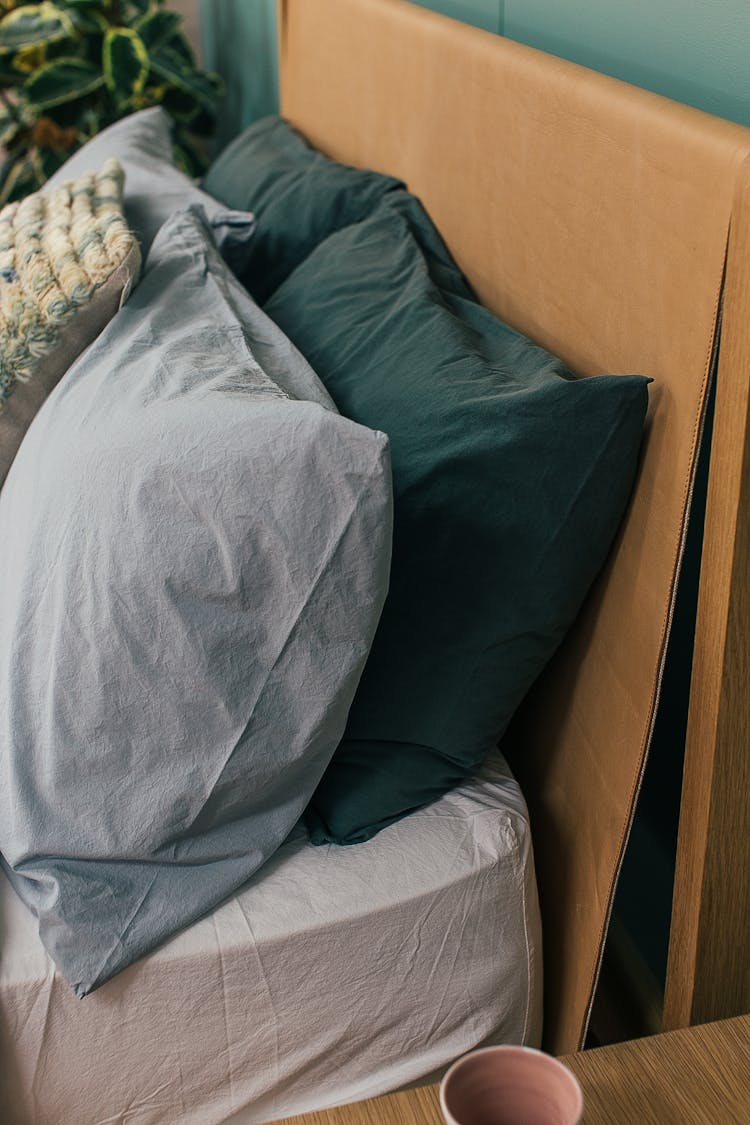 Colorful Pillows Placed On Bed In Bedroom