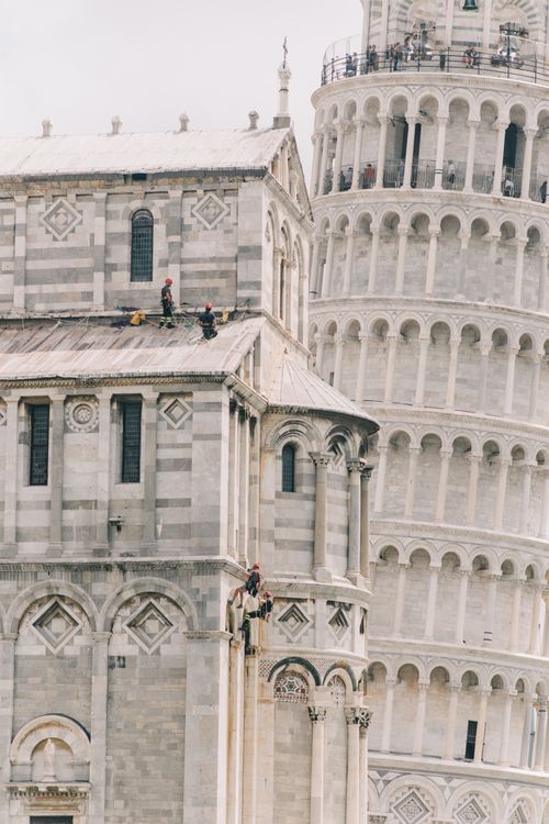 Free Exterior of famous stone building with ornamental details and leaning tower of Pisa Stock Photo