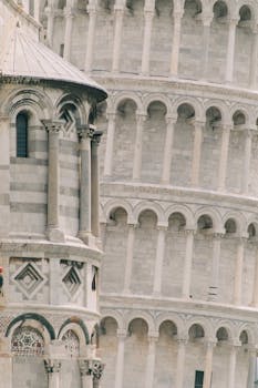 Detailed view of the Leaning Tower of Pisa, highlighting its Romanesque architecture.