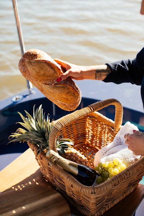 Free Crop woman with basket of food on yacht Stock Photo