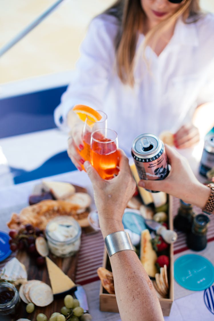 Crop People Clinking Glasses With Drinks