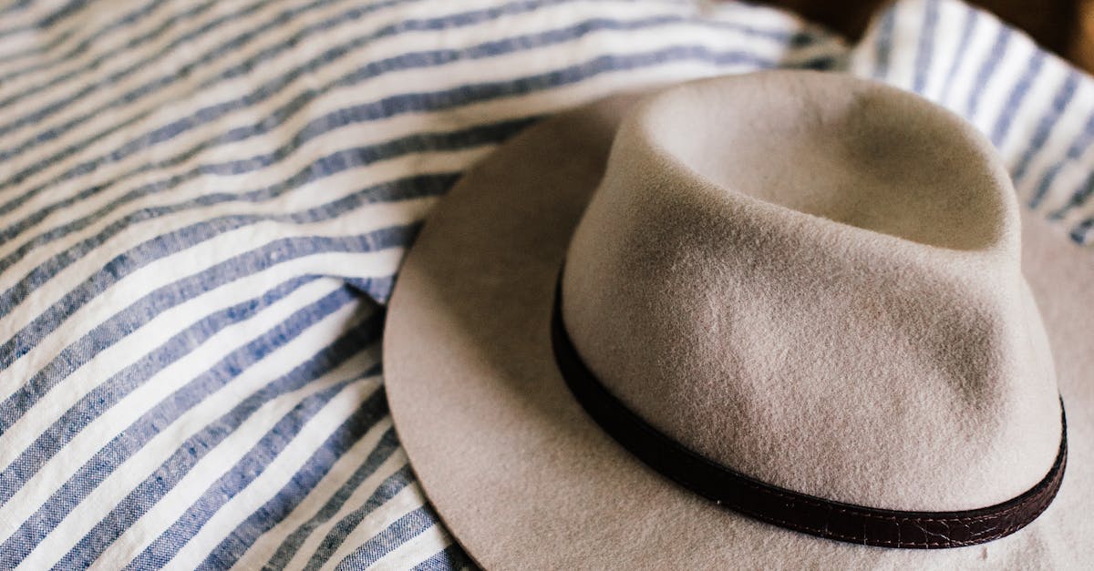Hat on unmade bed with blanket · Free Stock Photo