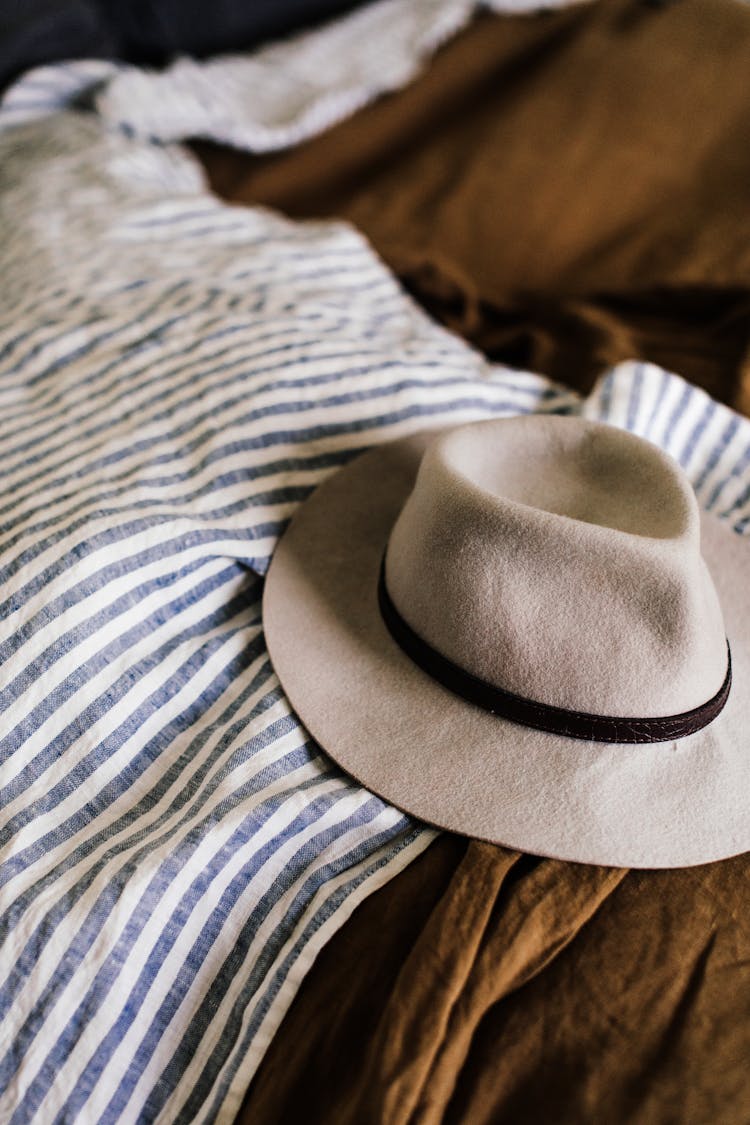 Hat On Unmade Bed With Blanket