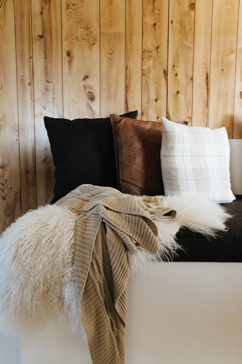 Comfy sofa with plaids and pillows