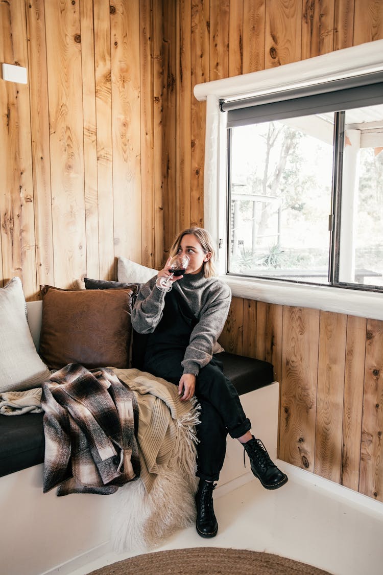 Woman On Sofa Drinking Wine