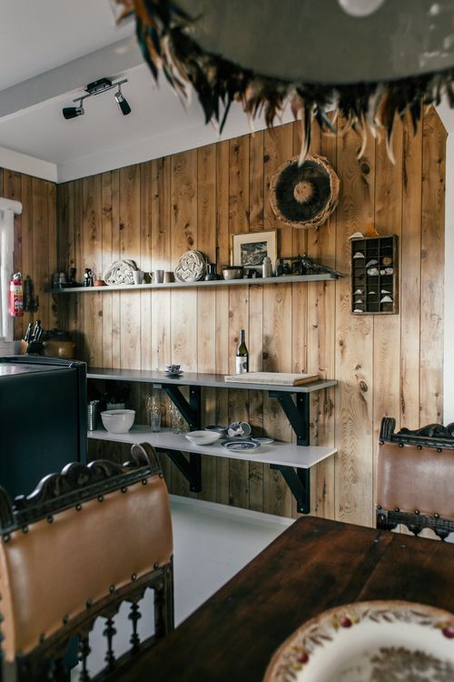 Free Interior of cozy kitchen in country style with shelves and dining zone at home Stock Photo