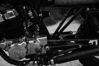 Black and white of old vintage motorbike wheel and units of engine and gearbox