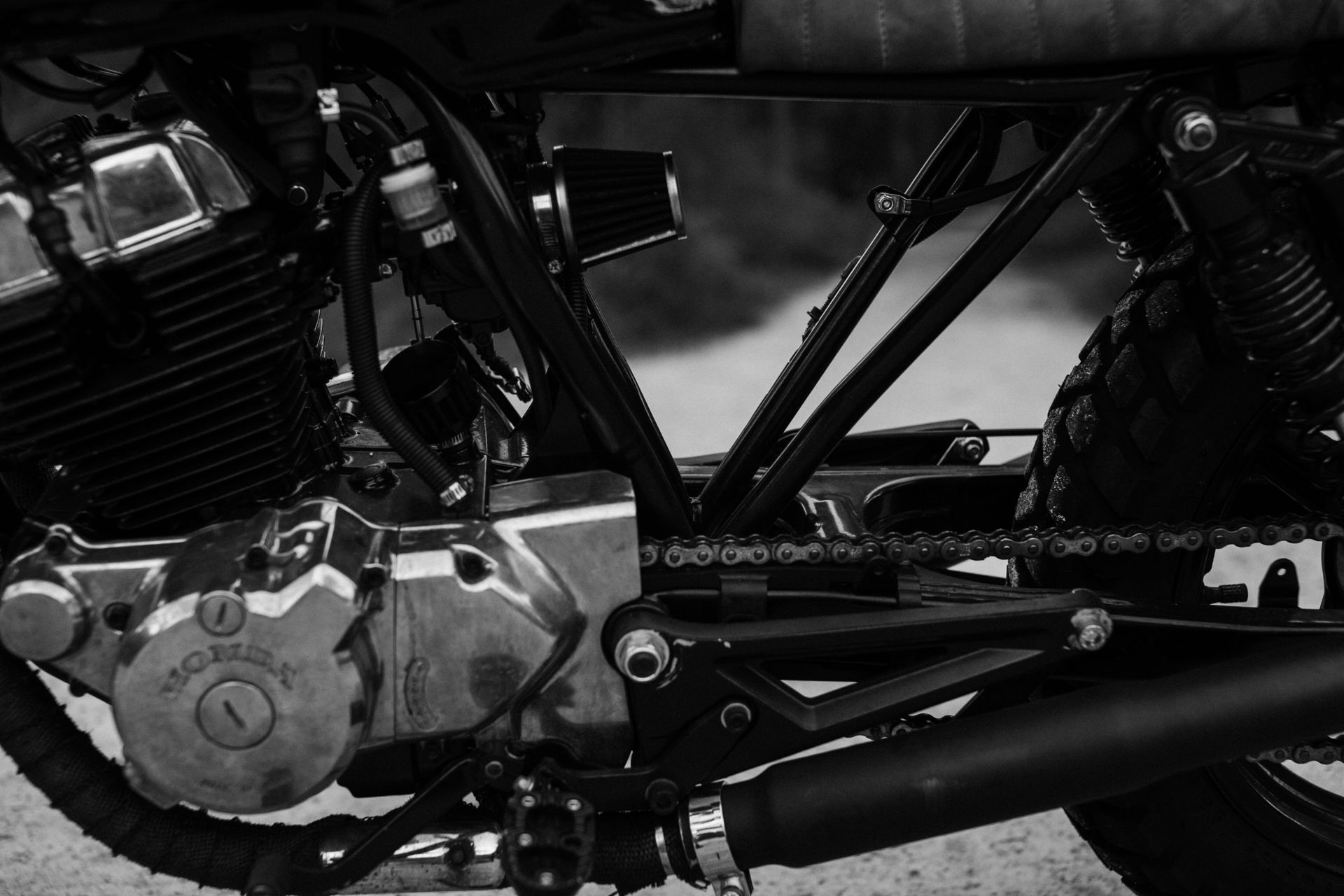 Black and white of old vintage motorbike wheel and units of engine and gearbox