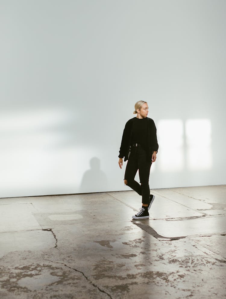 Young Man Walking On Big Hallway