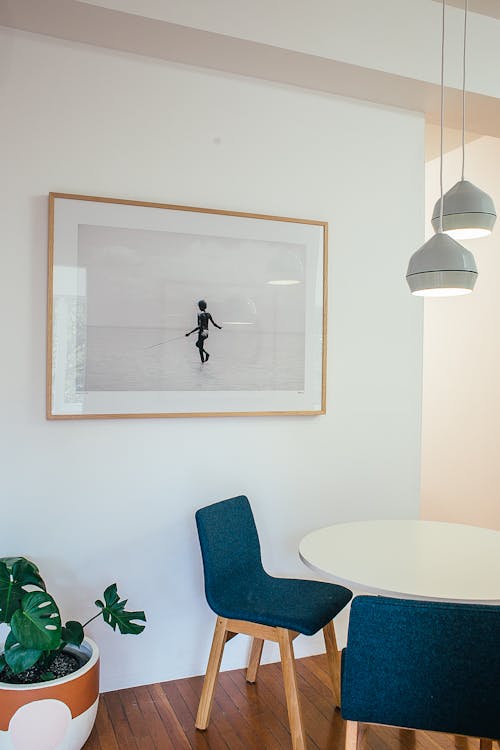 Interior of room with chairs and table near picture