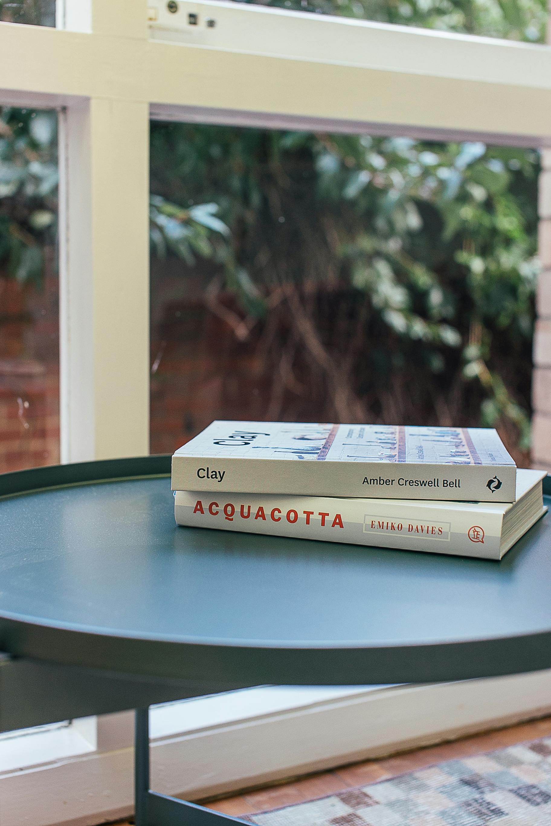 round table with books near window