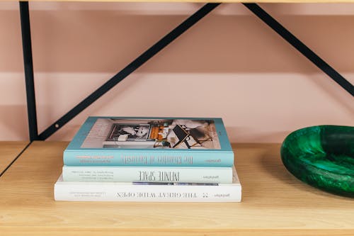 Free Shelf with books placed near wall Stock Photo