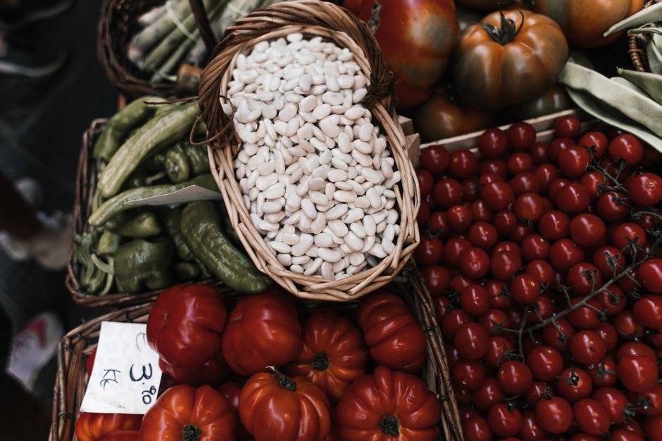 From above of assorted fresh ripe vegetables placed on stall in local grocery market
