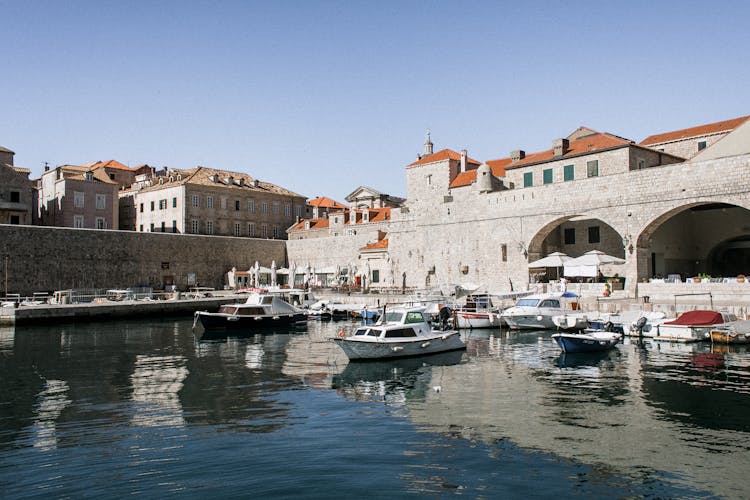 Old City Port With Motor Boats On Sea