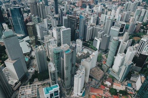 Aerial view of contemporary city district with tall glass skyscrapers of futuristic style in daylight
