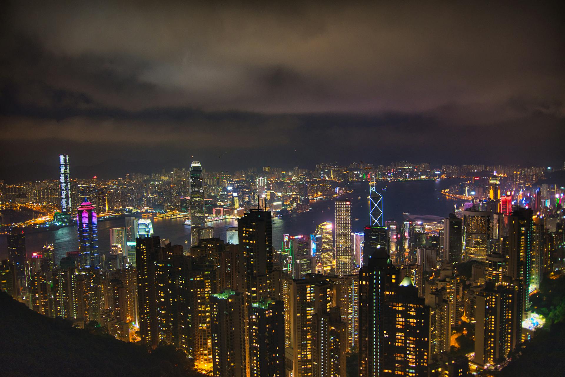 Breathtaking view of Hong Kong's vibrant skyline and Victoria Harbour at night from Victoria Peak.