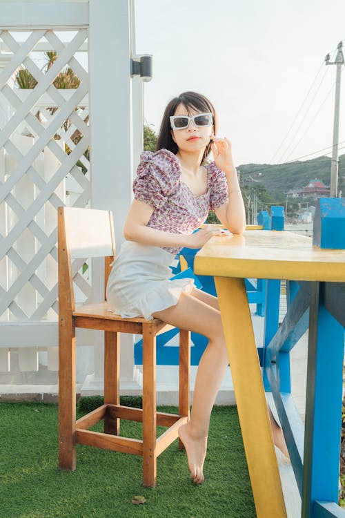 Trendy woman sitting in outdoor cafe