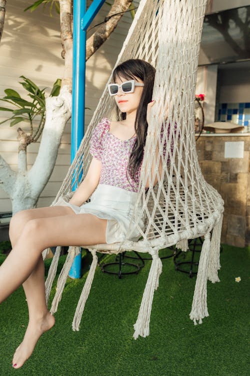 Relaxed woman chilling in hanging chair