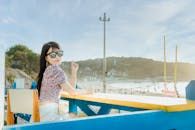 Content woman sitting at table near coast