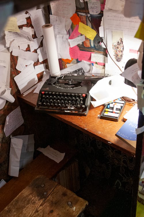 Cluttered cramped workplace with typewriter papers