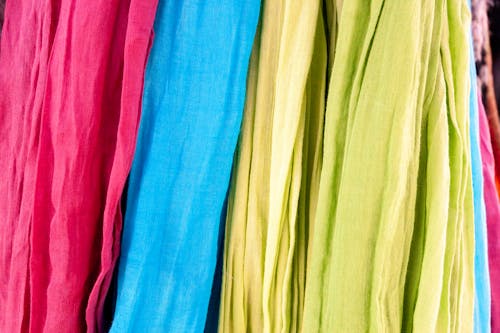 Cotton bright clothes in folds placed in order for sale in local bazaar