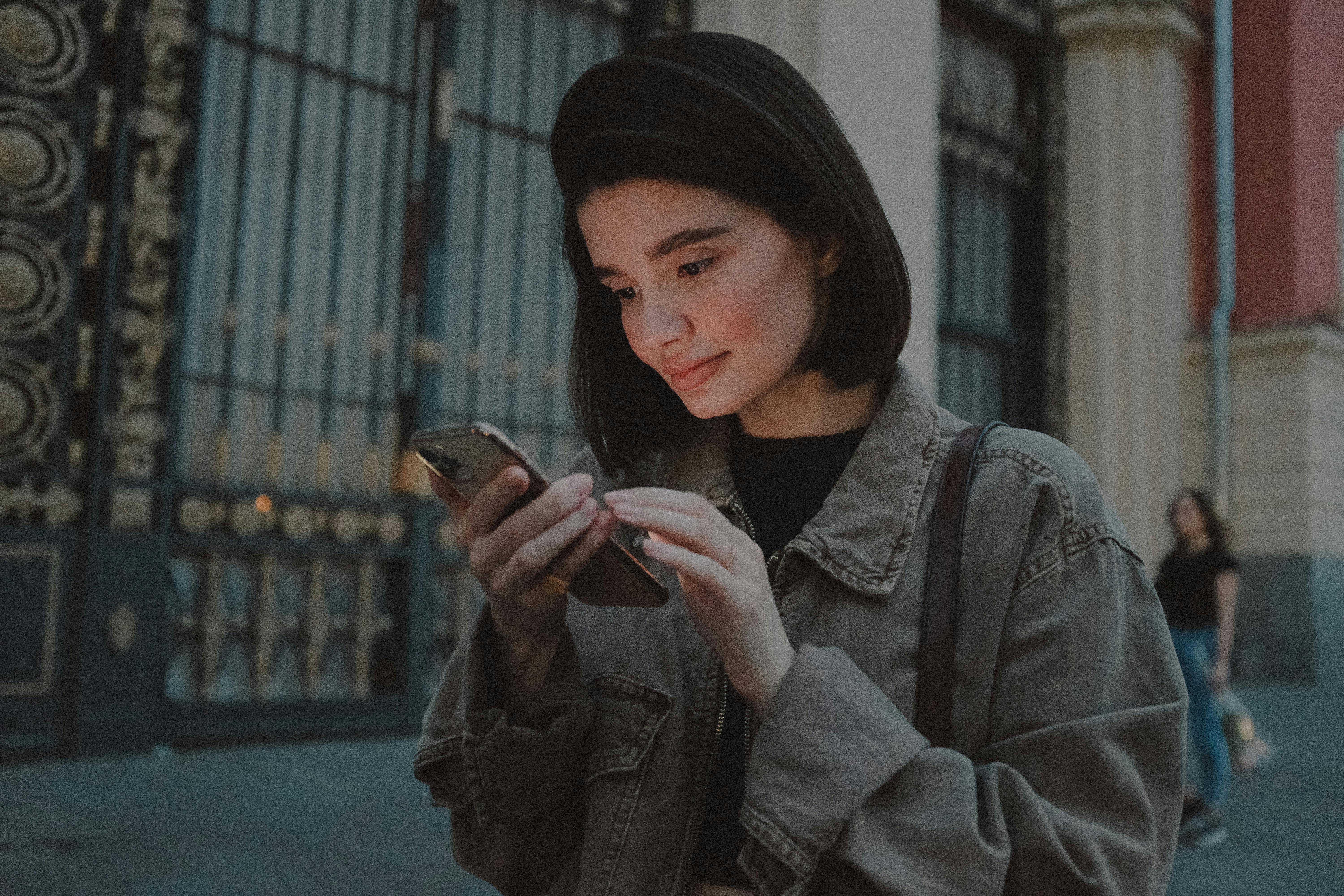 young woman using smartphone on street