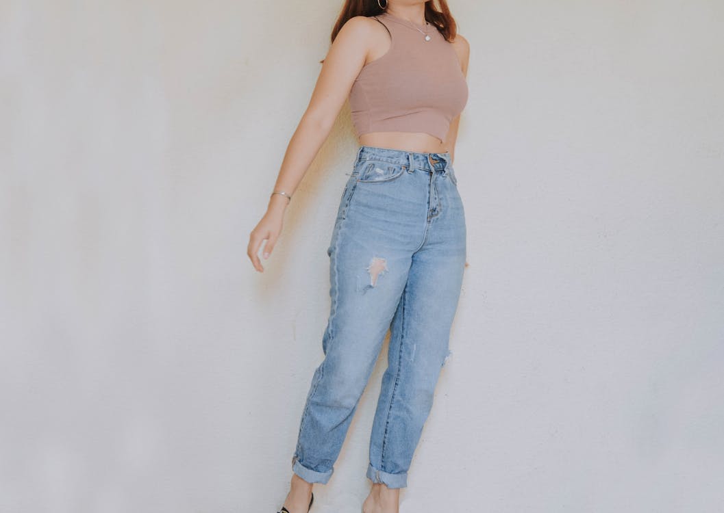 Woman in Brown Crop Top and Denim Jeans