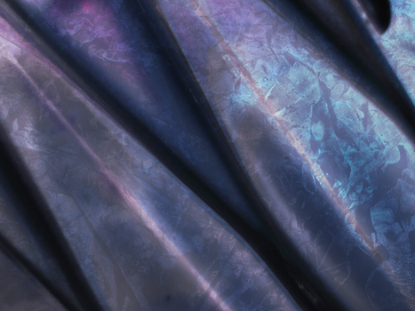 Close-up of a shimmering metallic fabric with abstract purple and blue patterns, ideal for modern design.