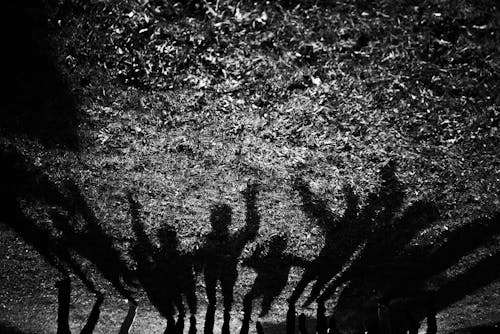 Shadows of People with Arms Raised