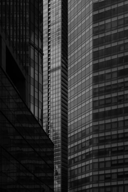 Black and white of contemporary multistage dwelling building exteriors in town in twilight