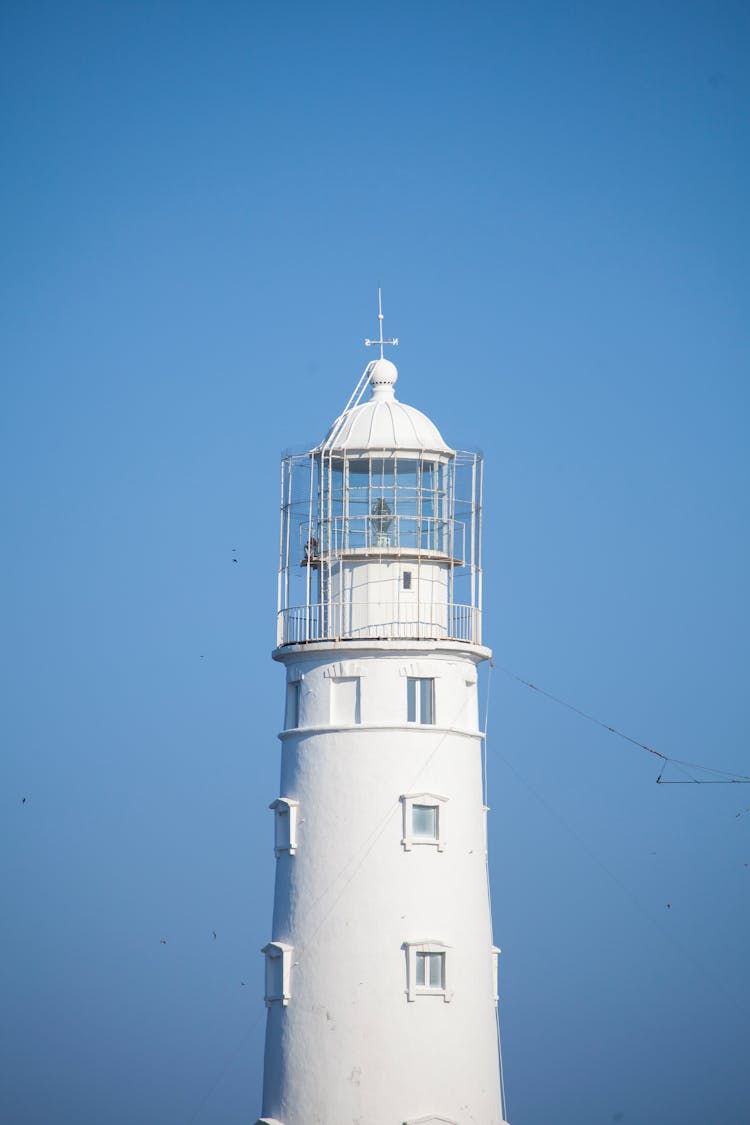 White Lighthouse And Blue Sky