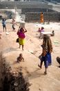 Women Carrying Blocks on Heads in Village