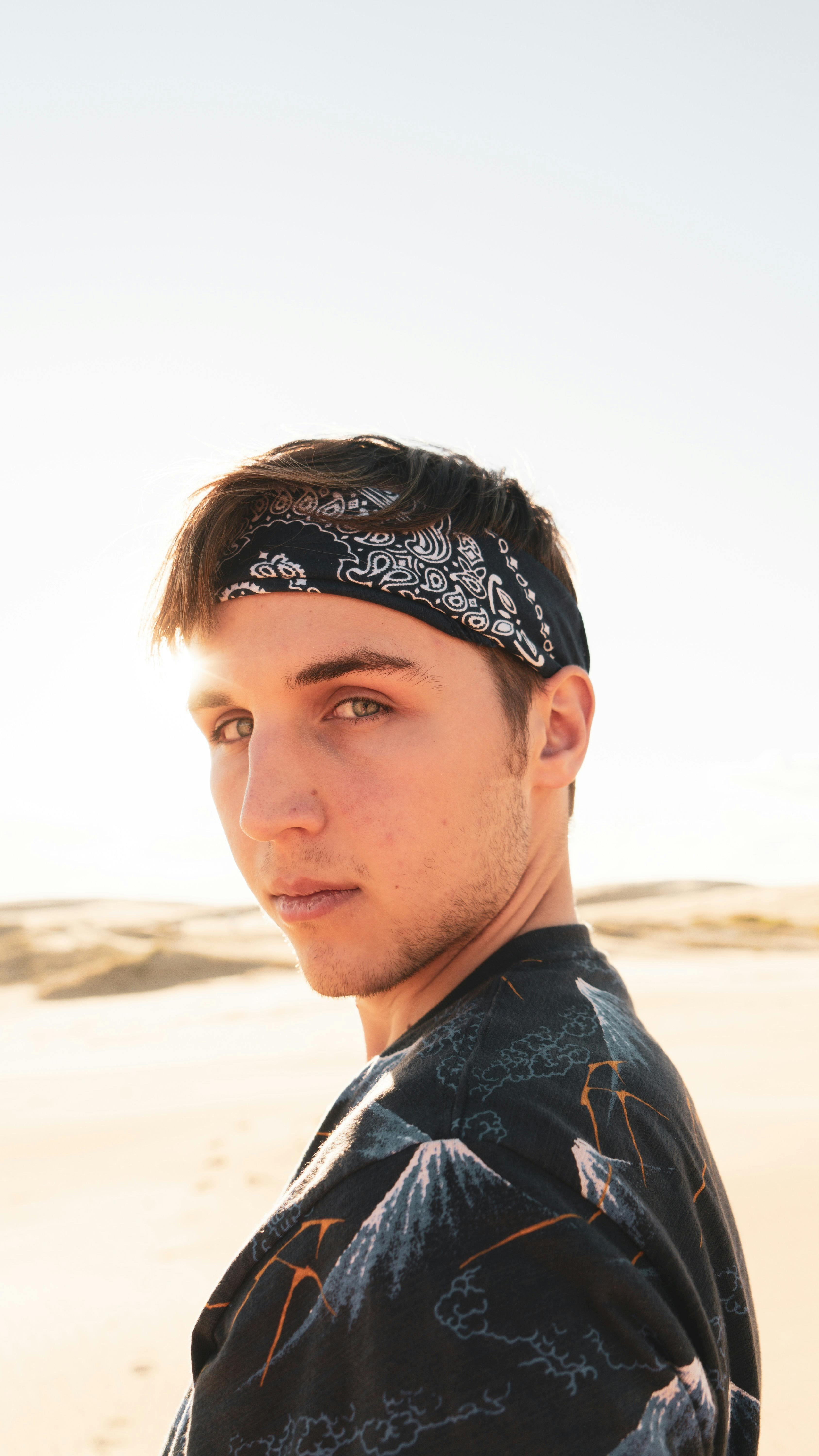 stylish man in bandana on sunny beach