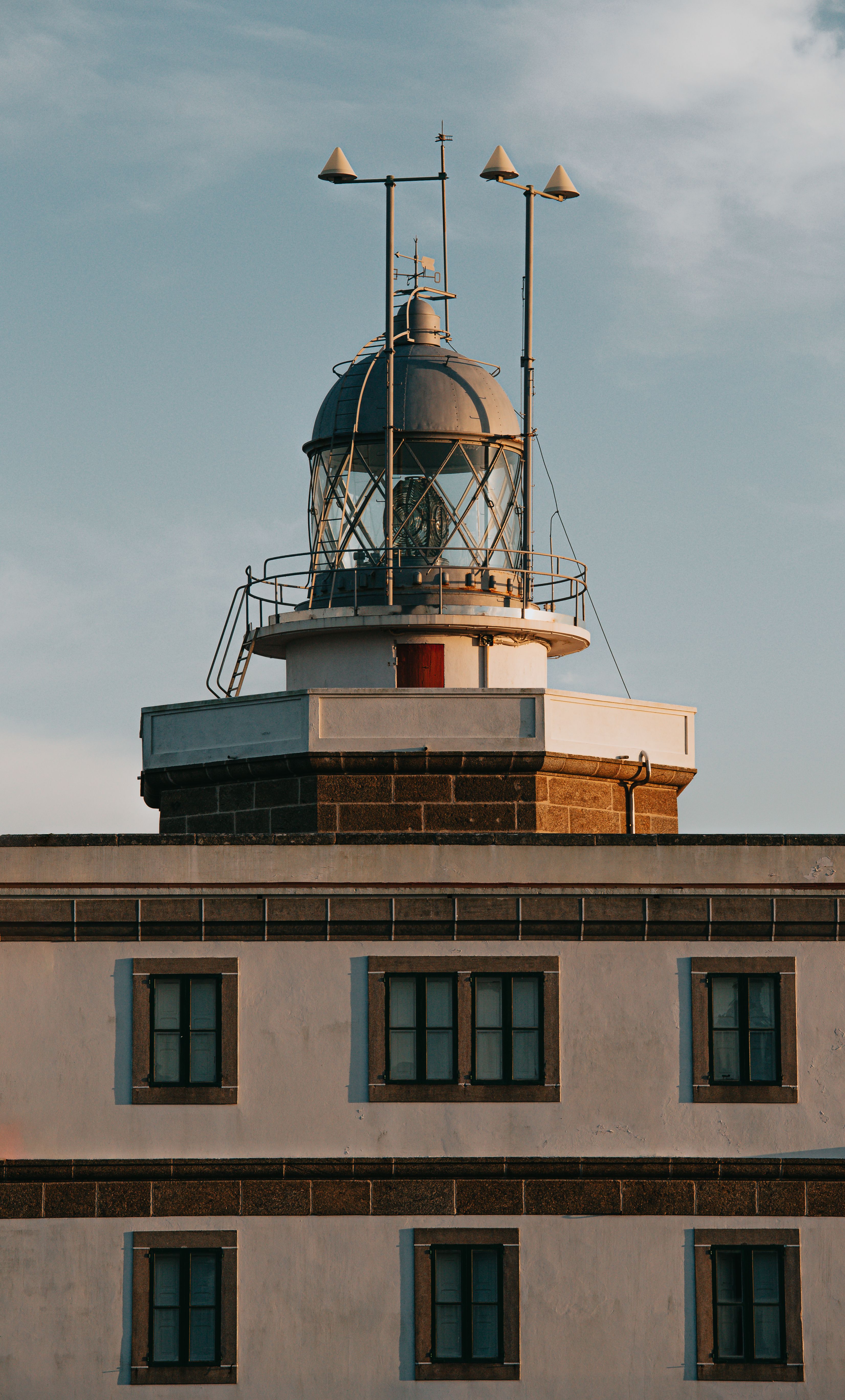 Old building with lighthouse under cloudy sky · Free Stock Photo
