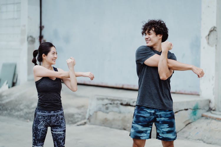 Smiling Couple Training Together Outdoors