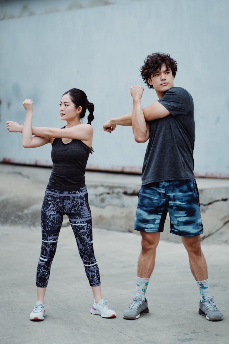 Young Couple Athletes Training Outside Together